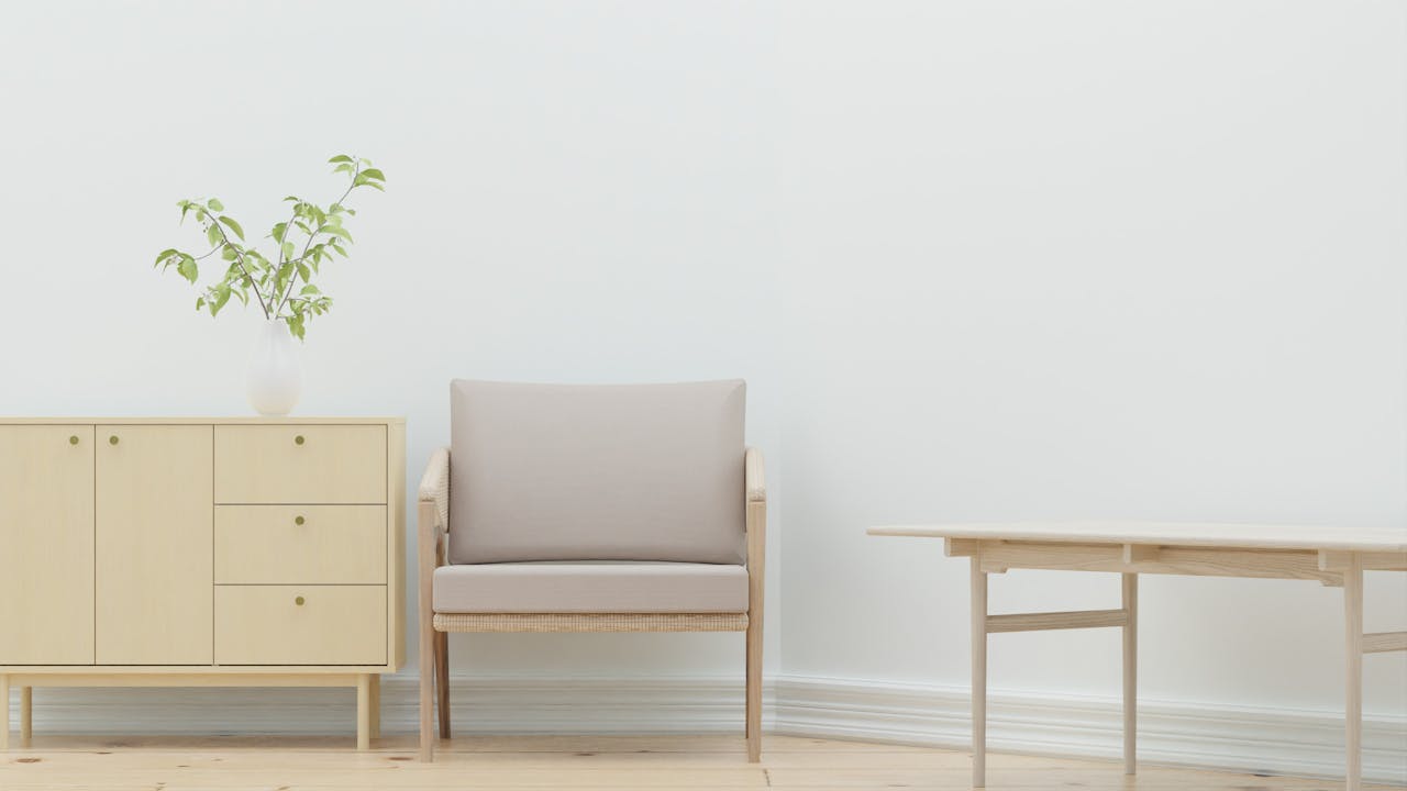 services-01 A serene minimalist living room with wooden furniture and a plant.