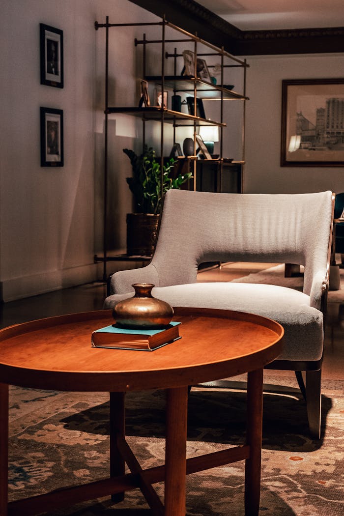 gallery-6 Sophisticated and cozy living room with an elegant armchair and round table enhancing the decor.